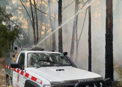 Extinguishing burning trees from water tank on back of vehicle